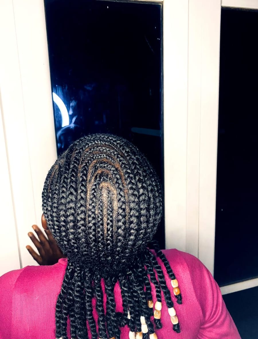 Neat cornrowed knotless braids finished with wooden and cream beads