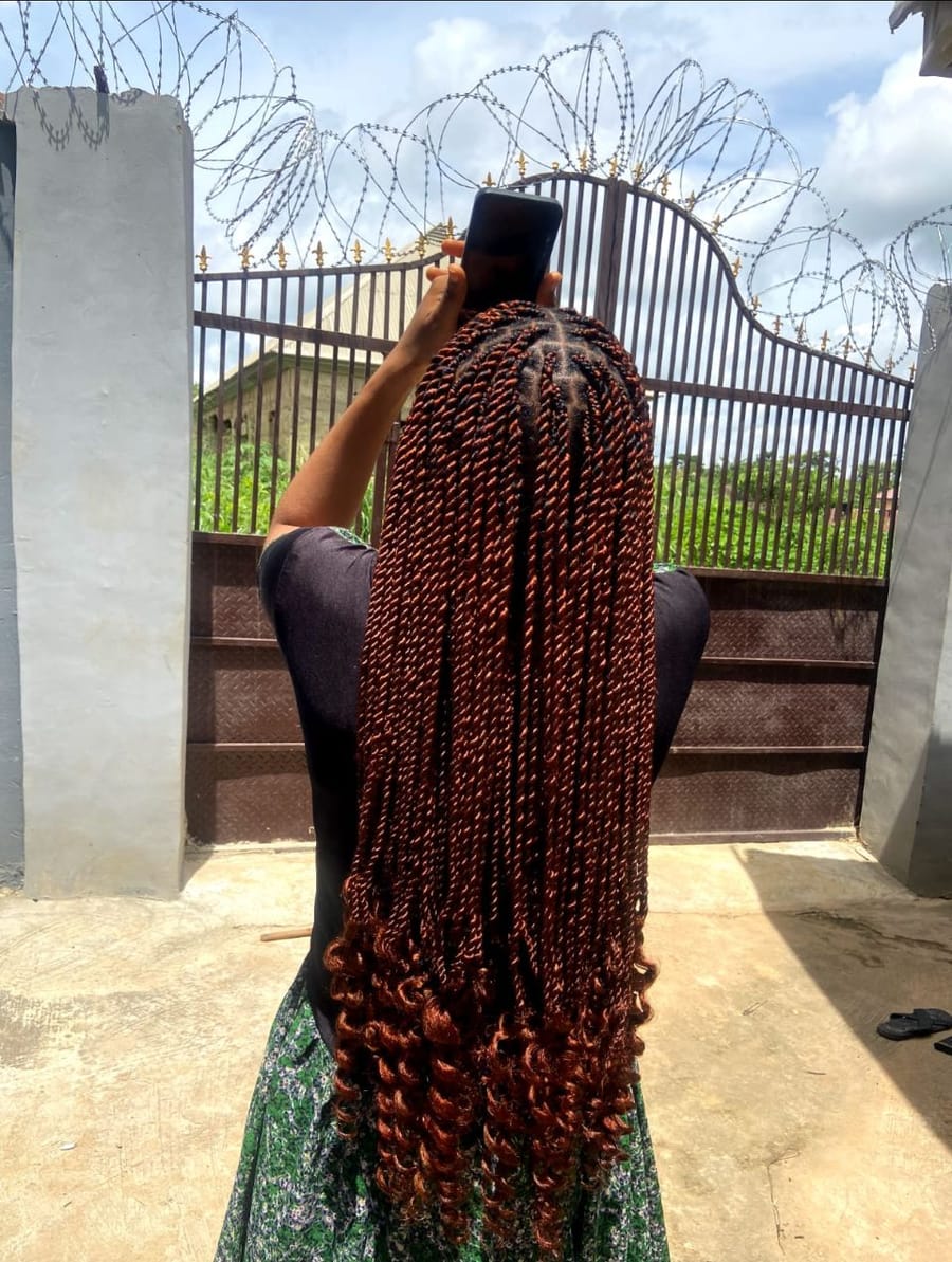 Waist-length copper senegalese twists with curled ends
